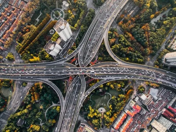 An aerial view of highway interchanges running through a city.